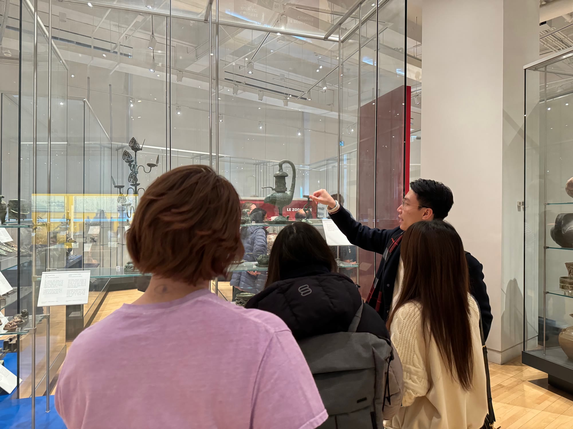 Student guide in a gallery of Chinese bronzes