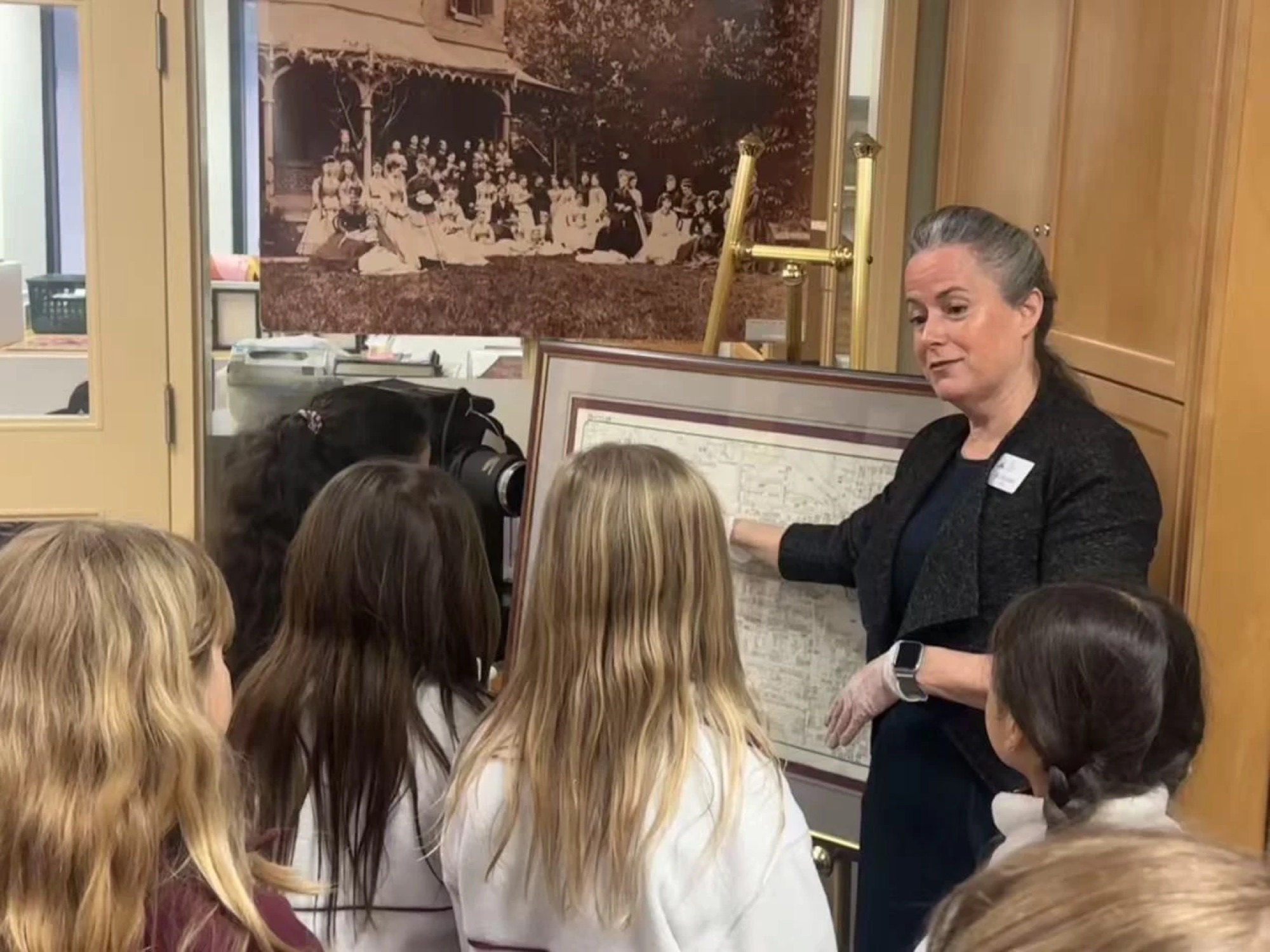 Students gathered around a historic map
